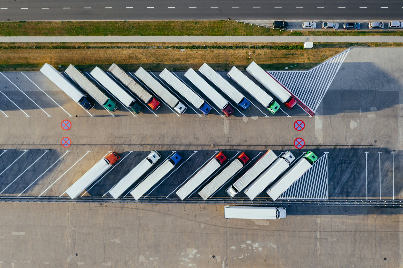 Aerial view of semi-trucks parked in rows at a logistics yard