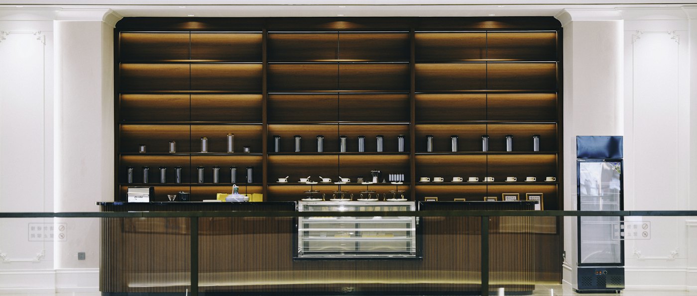 Retail counter with illuminated wooden display shelves